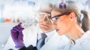 Image of two scientists in lab coats studying results in a lab. best biotech stocks to buy